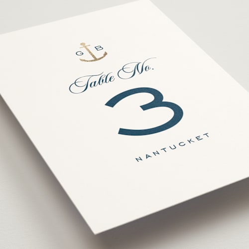 This is a royal navy table numbers with foil pressed by Olivia Raufman called anchored printing on doublethick in standard