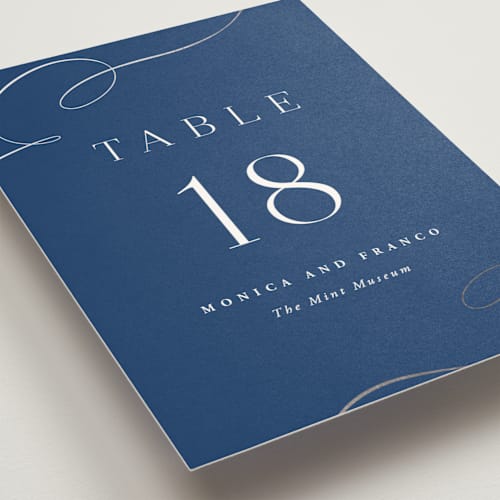 This is a royal blue table numbers with foil pressed by Hooray Creative called and centered printing on doublethick in standard
