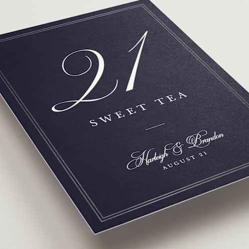 This is a navy table numbers with foil pressed by Sarah Brown called traditionalist printing on doublethick in standard