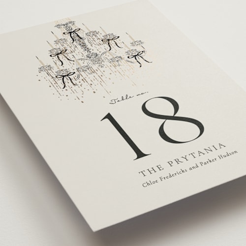 This is a noir table numbers with foil pressed by Jackie Crawford called hand illustrated whimsical chandelier printing on doublethick in standard