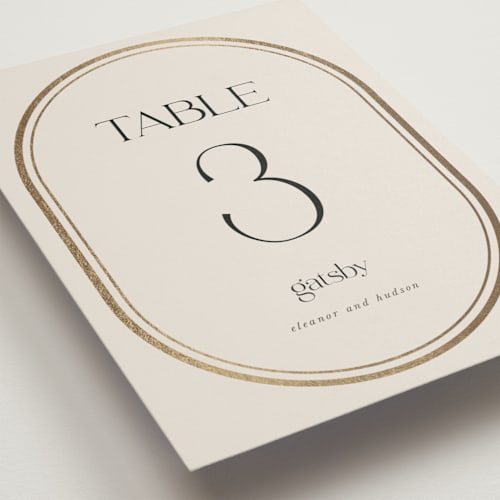 This is a sandstone table numbers with foil pressed by Lori Wemple called oval printing on doublethick in standard