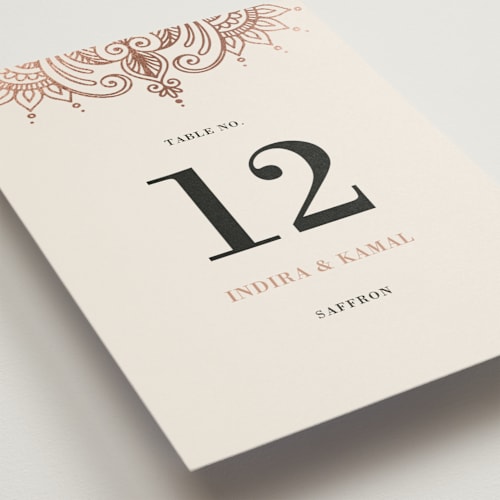 This is a champagne rose table numbers with foil pressed by Oma N. Ramkhelawan called regal mehndi printing on doublethick in standard