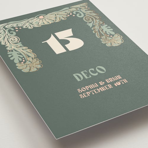 This is a sage table numbers with foil pressed by GeekInk Design called nouveau frame printing on doublethick in standard
