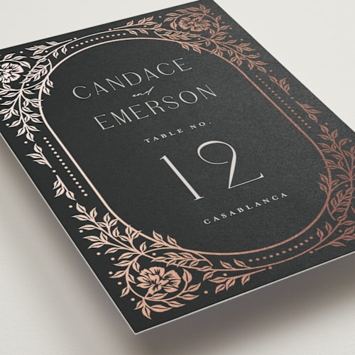 This is a onyx table numbers with foil pressed by Ana de Sousa called gilded nouveau frame printing on doublethick in standard