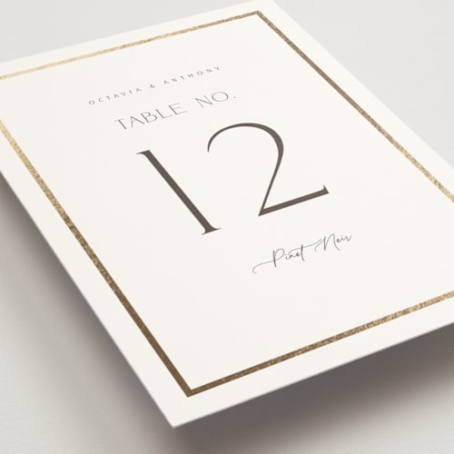 This is a porcelain table numbers with foil pressed by Nicole Walsh called regal printing on doublethick in standard