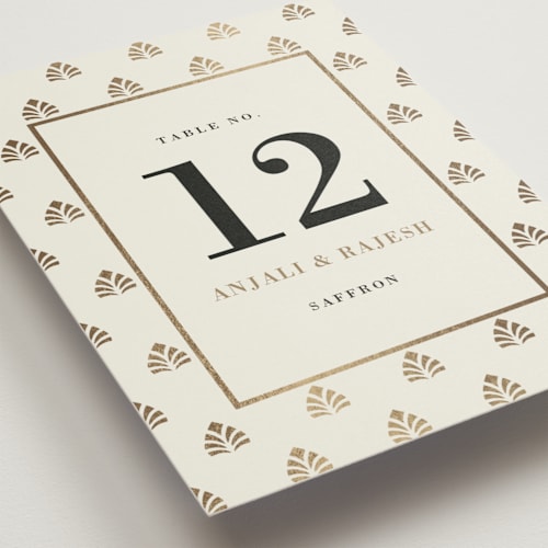 This is a champagne table numbers with foil pressed by Oma N. Ramkhelawan called henna stamp printing on doublethick in standard
