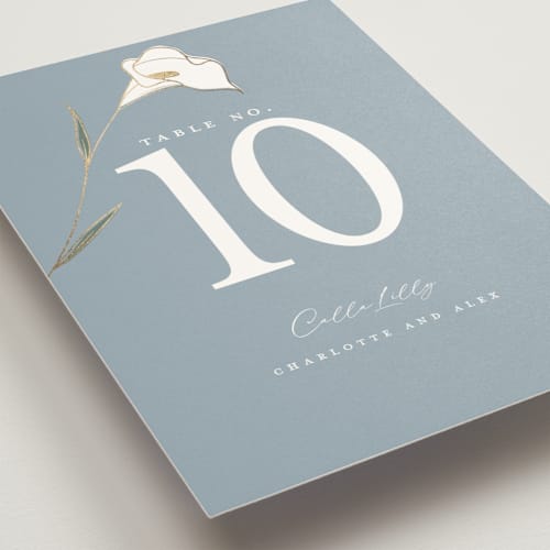 This is a dusty blue table numbers with foil pressed by Stacey Meacham called elegant lillies printing on doublethick in standard