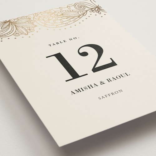 This is a champagne table numbers with foil pressed by Oma N. Ramkhelawan called elegant henna printing on doublethick in standard