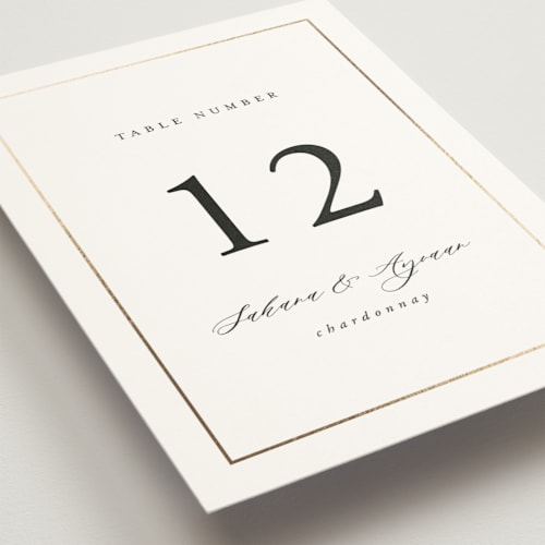This is a pearl table numbers with foil pressed by Nicole Walsh called gilded frame printing on doublethick in standard