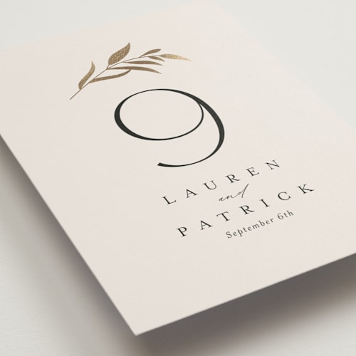 This is a porcelain table numbers with foil pressed by Jennifer Postorino called natural monogram printing on doublethick in standard