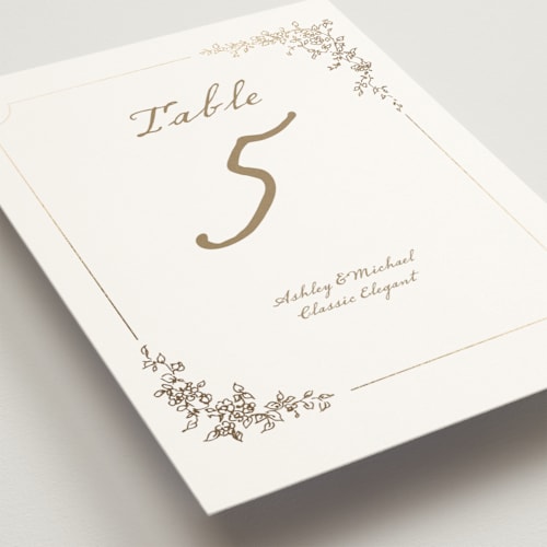 This is a ivory table numbers with foil pressed by Cass Loh called boho flower crest printing on doublethick in standard