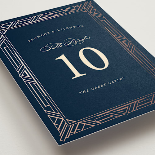 This is a navy table numbers with foil pressed by Hooray Creative called opulent border printing on doublethick in standard