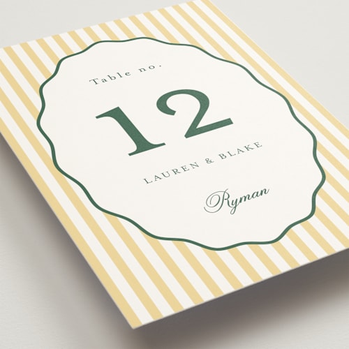 This is a citrine table numbers with standard by Emily Betts called curved frame printing on doublethick in standard