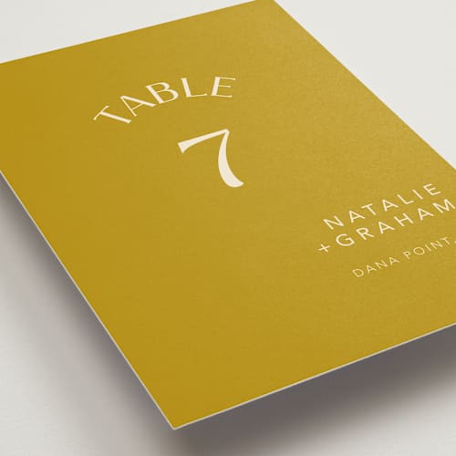 This is a marigold table numbers with standard by Stacey Day called swoop printing on doublethick in standard