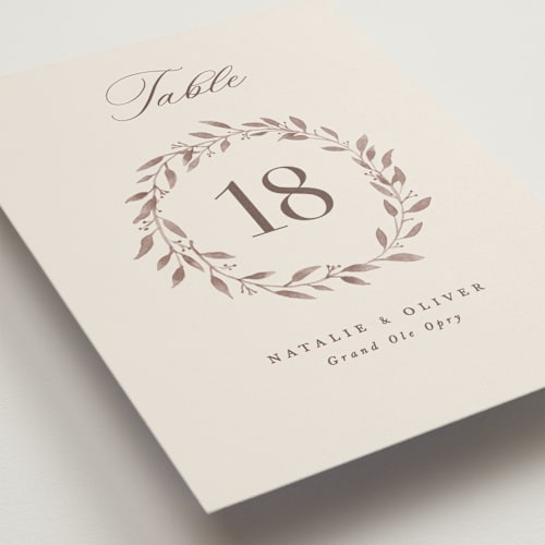 This is a ecru table numbers with standard by Hooray Creative called delicate monogram printing on doublethick in standard