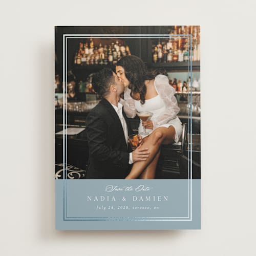 This is a slate blue foil stamped save the date cards with foil pressed by Nicole Walsh called shimmer printing on recycled smooth signature in standard