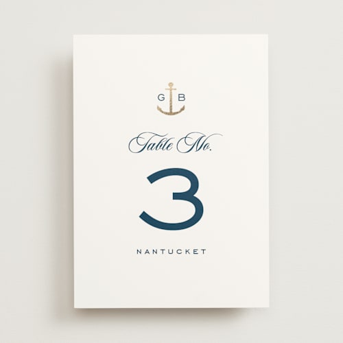 This is a royal navy table numbers with foil pressed by Olivia Raufman called anchored printing on doublethick in standard