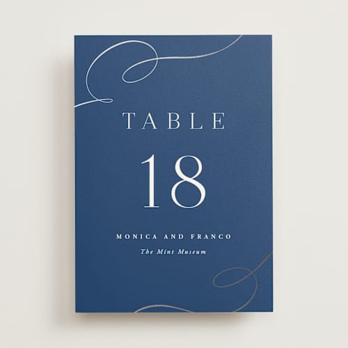 This is a royal blue table numbers with foil pressed by Hooray Creative called and centered printing on doublethick in standard