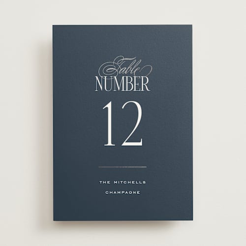 This is a navy table numbers with foil pressed by Leah Bisch called unite printing on doublethick in standard