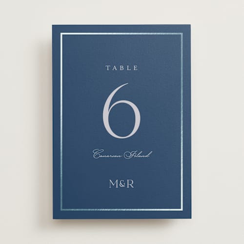 This is a deep sea table numbers with foil pressed by Lucrecia Caporale called timeless charm printing on doublethick in standard