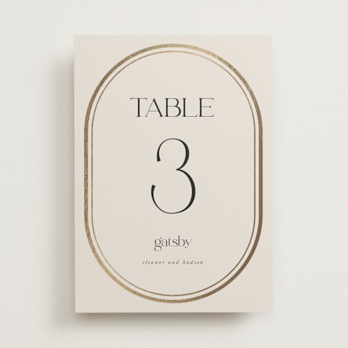This is a sandstone table numbers with foil pressed by Lori Wemple called oval printing on doublethick in standard