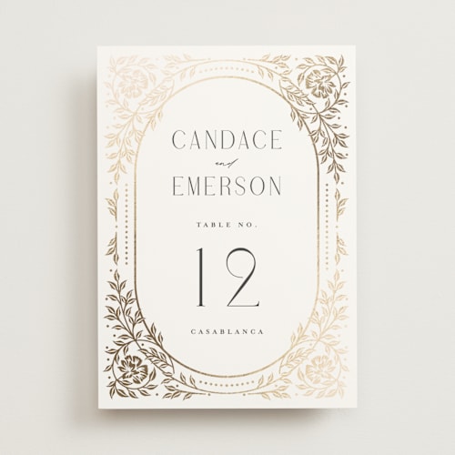 This is a ivory table numbers with foil pressed by Ana de Sousa called gilded nouveau frame printing on doublethick in standard