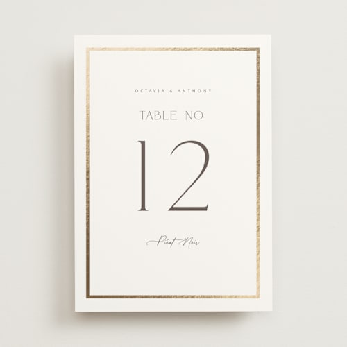 This is a porcelain table numbers with foil pressed by Nicole Walsh called regal printing on doublethick in standard