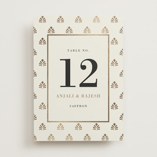 This is a champagne table numbers with foil pressed by Oma N. Ramkhelawan called henna stamp printing on doublethick in standard