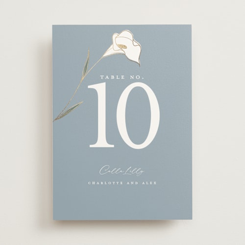 This is a dusty blue table numbers with foil pressed by Stacey Meacham called elegant lillies printing on doublethick in standard