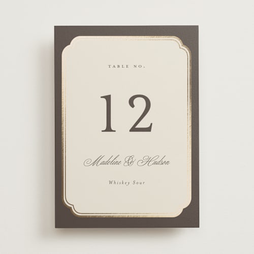This is a cognac table numbers with foil pressed by Emily Betts called arch frame printing on doublethick in standard