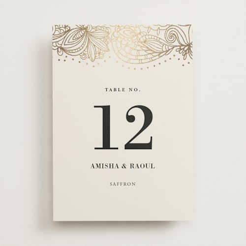 This is a champagne table numbers with foil pressed by Oma N. Ramkhelawan called elegant henna printing on doublethick in standard