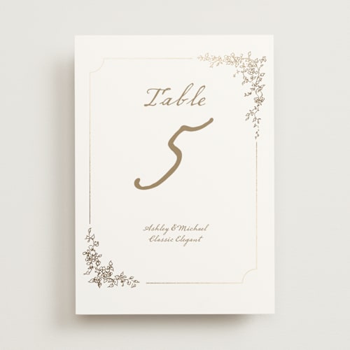 This is a ivory table numbers with foil pressed by Cass Loh called boho flower crest printing on doublethick in standard