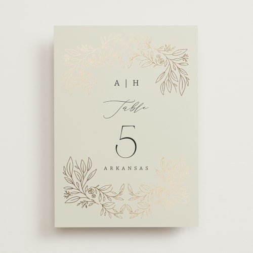 This is a taupe table numbers with foil pressed by Hannah Williams called foil botanical frame printing on doublethick in standard