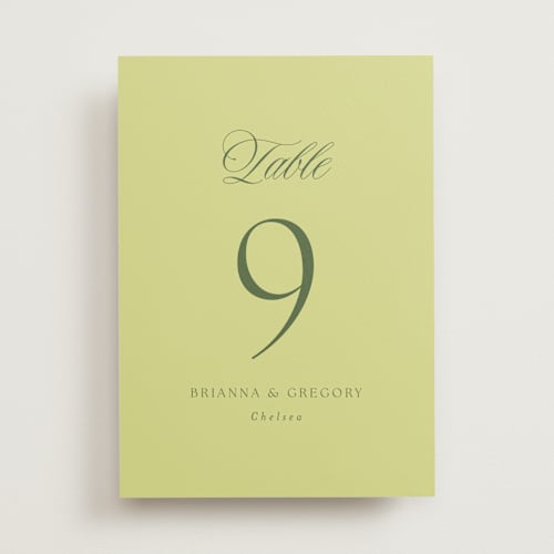 This is a chartreuse table numbers with standard by Everett Paper Goods called carlyle printing on doublethick in standard