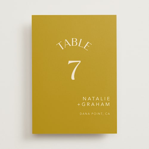 This is a marigold table numbers with standard by Stacey Day called swoop printing on doublethick in standard
