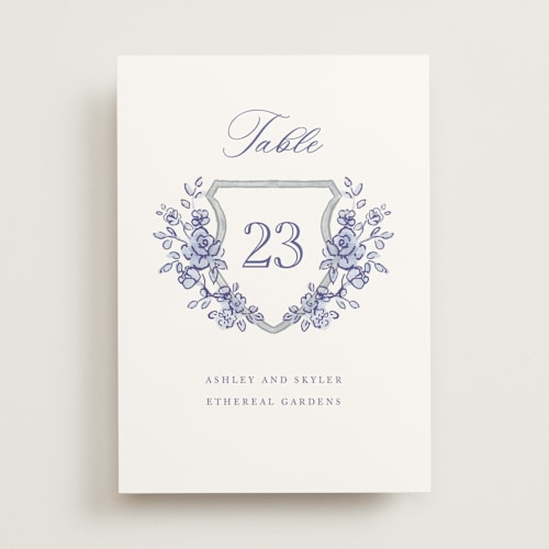 This is a dusty blue table numbers with standard by Cass Loh called watercolor flowers crest printing on doublethick in standard