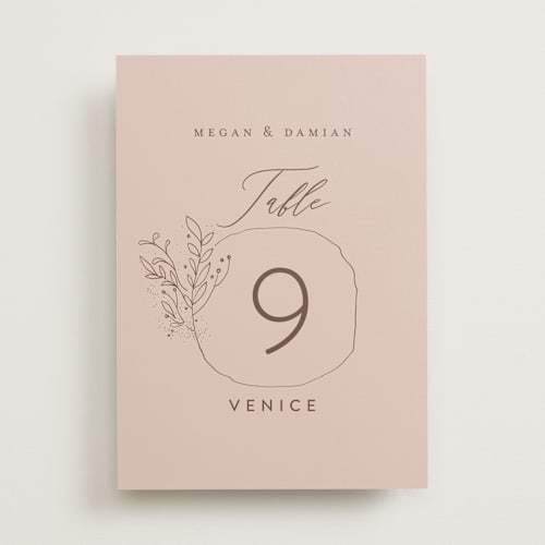 This is a blush table numbers with standard by Lucrecia Caporale called delicate monogram printing on doublethick in standard