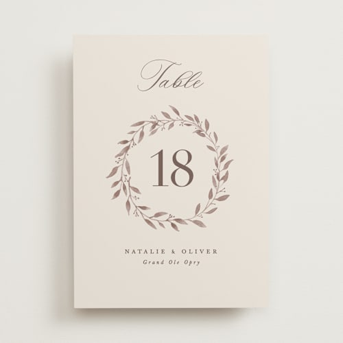 This is a ecru table numbers with standard by Hooray Creative called delicate monogram printing on doublethick in standard