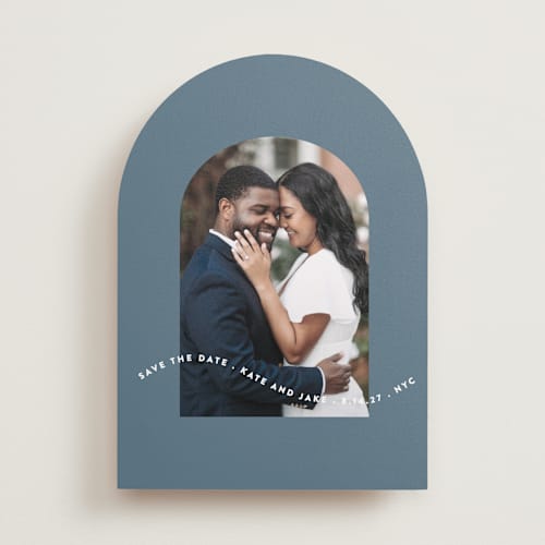 This is a dusty blue save the date with standard by Leah Ragain called wavy arch printing on recycled smooth signature in standard