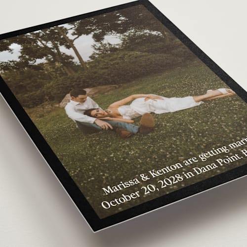 This is a coal petite save the dates with standard by Becky Nimoy called black border printing on recycled smooth signature in petite