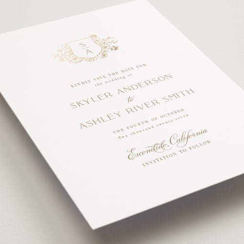 This is a champagne petite save the dates with foil pressed by Cass Loh called floral crest printing on signature in petite