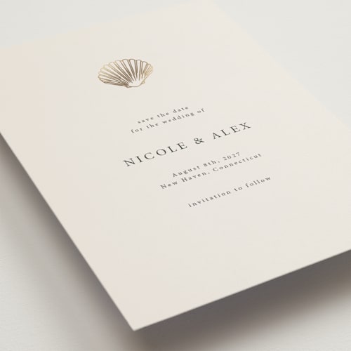 This is a sand petite save the dates with foil pressed by Hannah Bowman called simple seashell printing on signature in petite