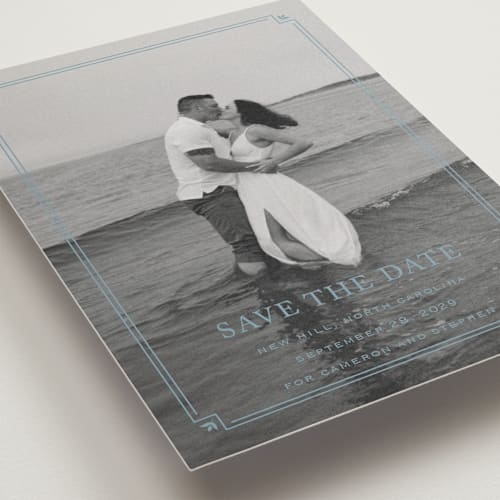 This is a french blue save the date postcards with standard by Carolyn MacLaren called fleur corner printing on signature in postcard