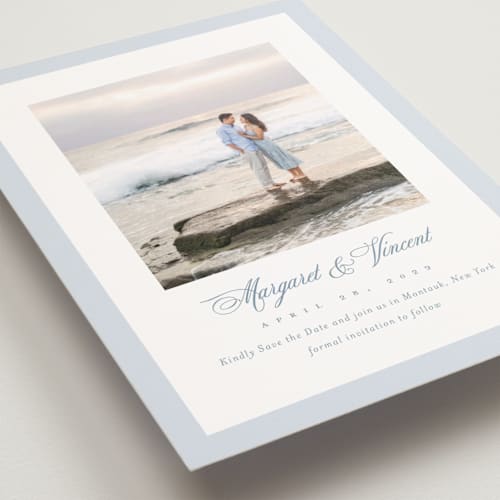 This is a dusty blue save the date postcards with standard by Jennifer Postorino called coastal charm printing on signature in postcard