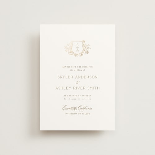 This is a champagne petite save the dates with foil pressed by Cass Loh called floral crest printing on signature in petite