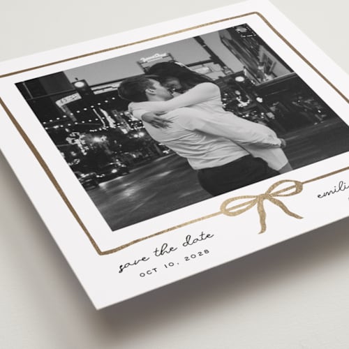This is a linen foil stamped save the date cards with foil pressed by Jennifer Lew called lil bow printing on recycled smooth signature in standard