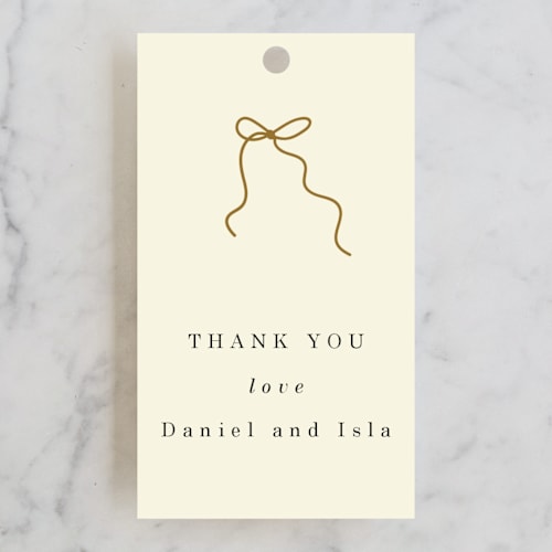 This is a cream wedding favor tags with standard by Baumbirdy called bows printing on signature in tag