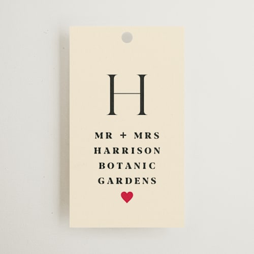 This is a ruby wedding favor tags with standard by Baumbirdy called pair of hearts from disney's alice in wonderland printing on signature in tag
