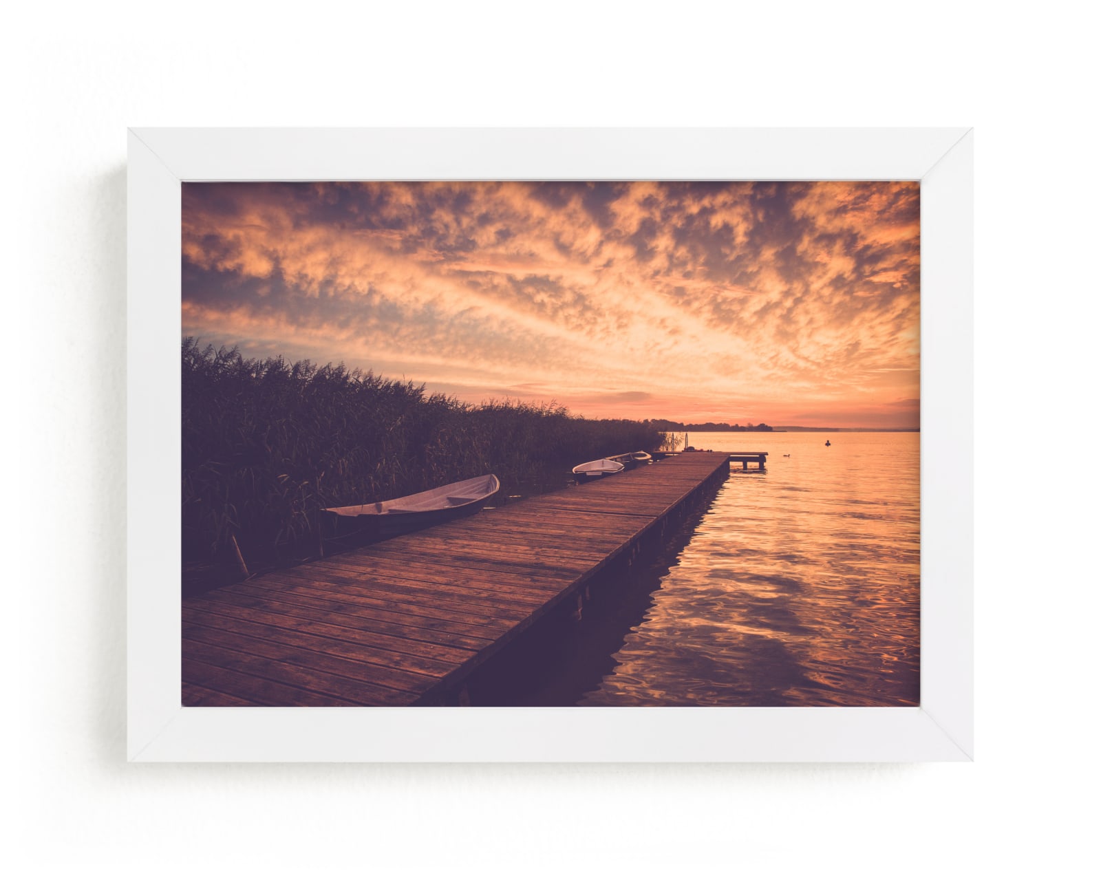 "Red sunset and boat" by Lying on the grass in beautiful frame options and a variety of sizes.