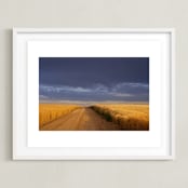 "Dirt Road Through a Wheat Field Under a Stormy Sky" - Art Print in Indigo Sky by Kathy Van Torne - Framed